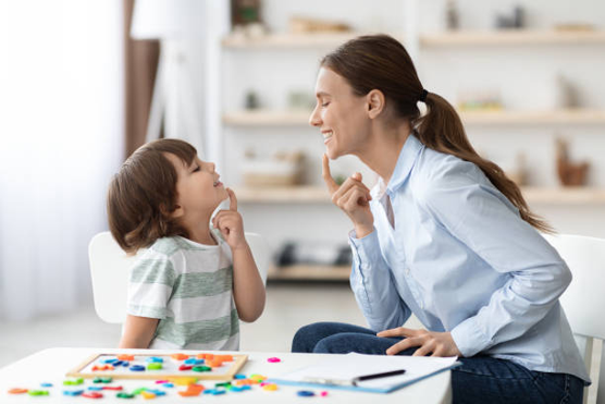 Speech therapist working with a young child during a play-based session